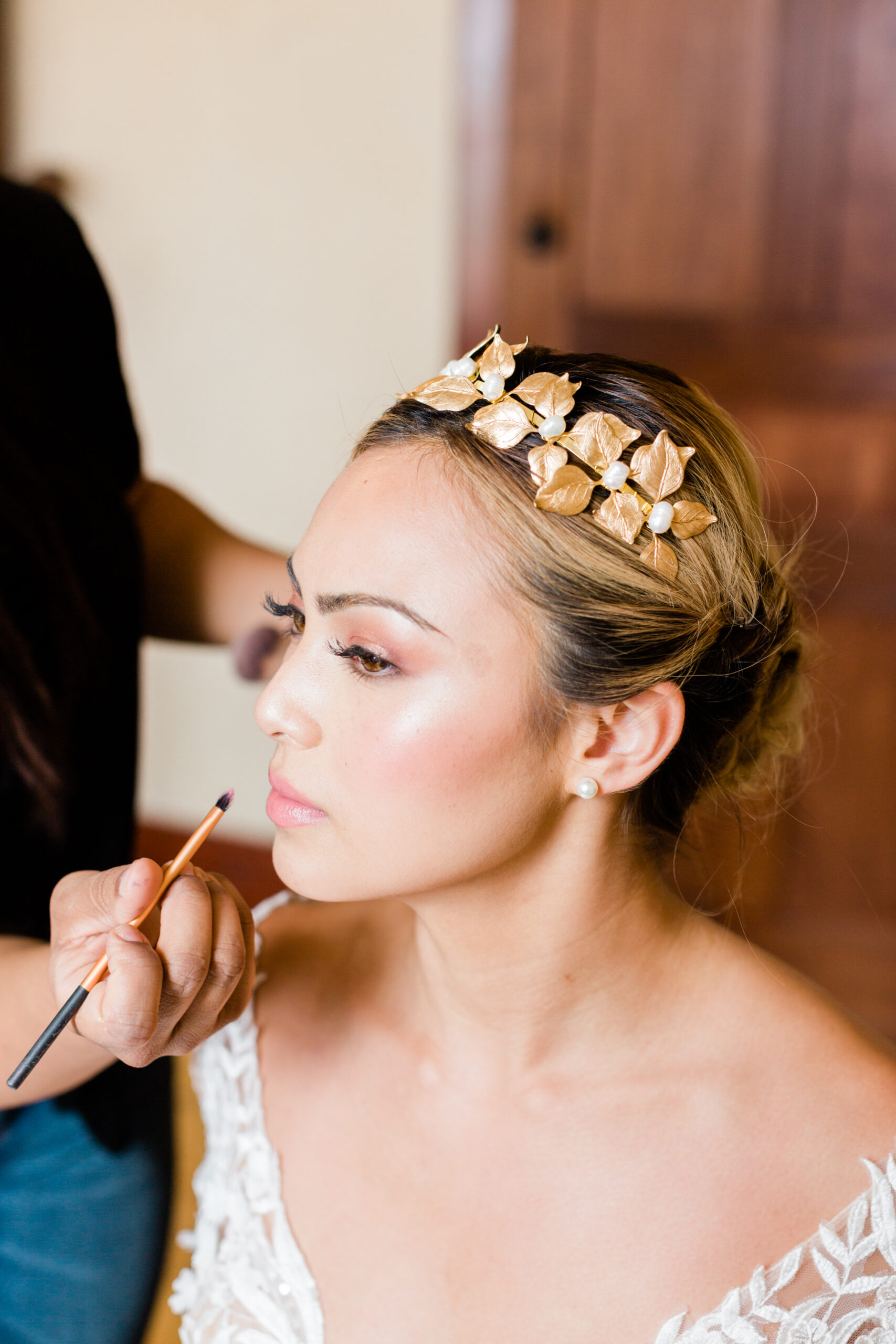 Bride having hair and makeup applied before her Kimball Home wedding in Salt Lake City