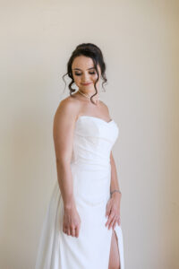 Bride getting ready at Hyatt Ziva Cabo San Lucas in natural window light before destination wedding ceremony