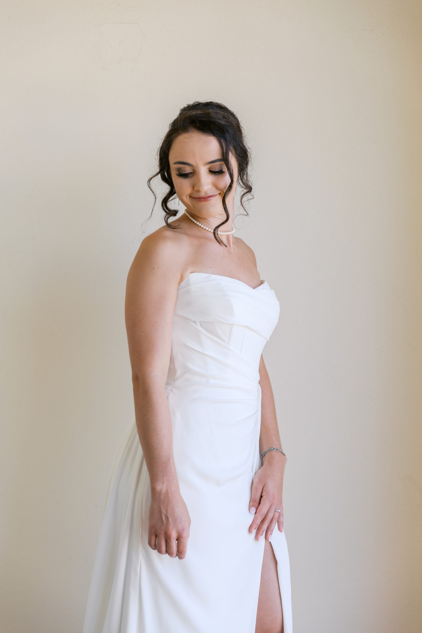 Bride getting ready at Hyatt Ziva Cabo San Lucas in natural window light before destination wedding ceremony