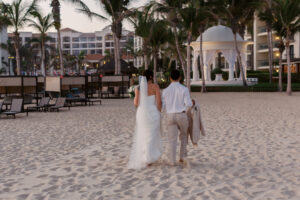 Hyatt Ziva Cabo San Lucas destination wedding couple walking on the beach toward the oceanfront gazebo ceremony location.