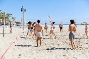 Guests playing beach volleyball during wedding weekend at Hyatt Ziva Los Cabos in Cabo San Lucas, Mexico.