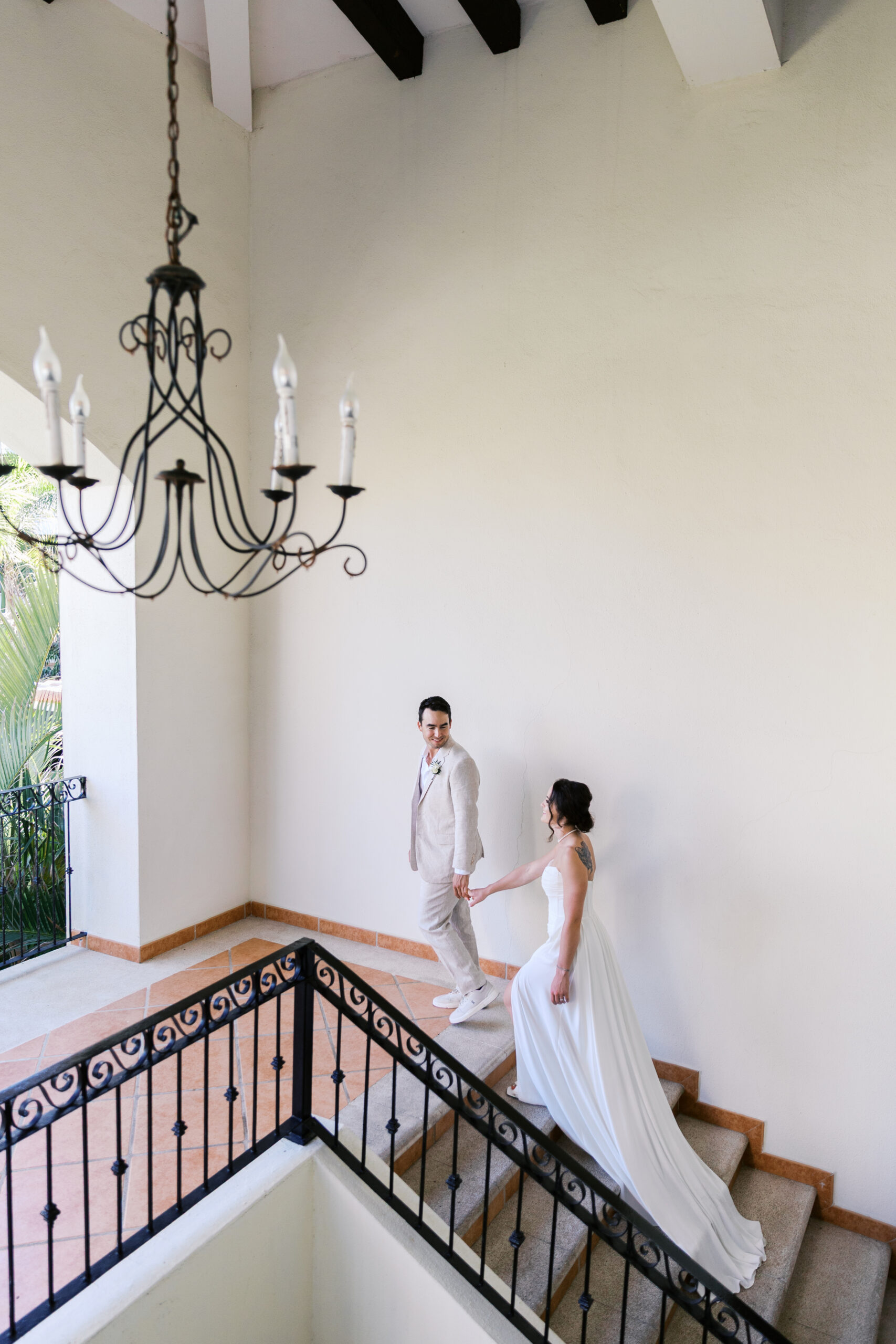 Bride and groom walking down staircase at Hyatt Ziva Los Cabos during destination wedding in Cabo.