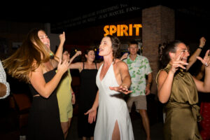 Bride dancing with guests at welcome party during Hyatt Ziva Los Cabos destination wedding in Cabo San Lucas.