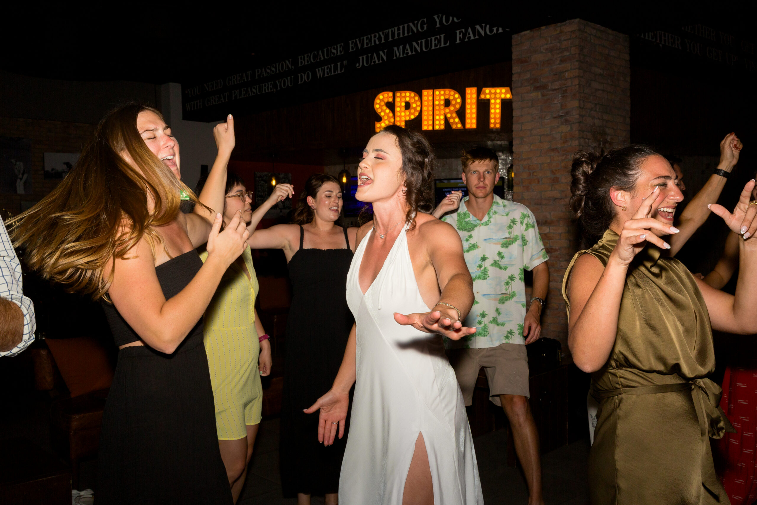 Bride dancing with guests at welcome party during Hyatt Ziva Los Cabos destination wedding in Cabo San Lucas.